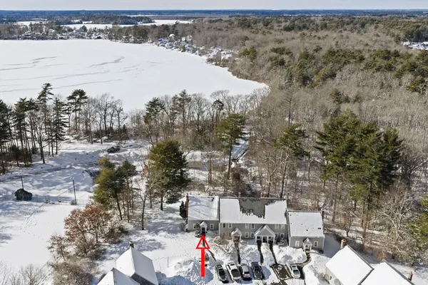 a view of a house with a yard covered in snow