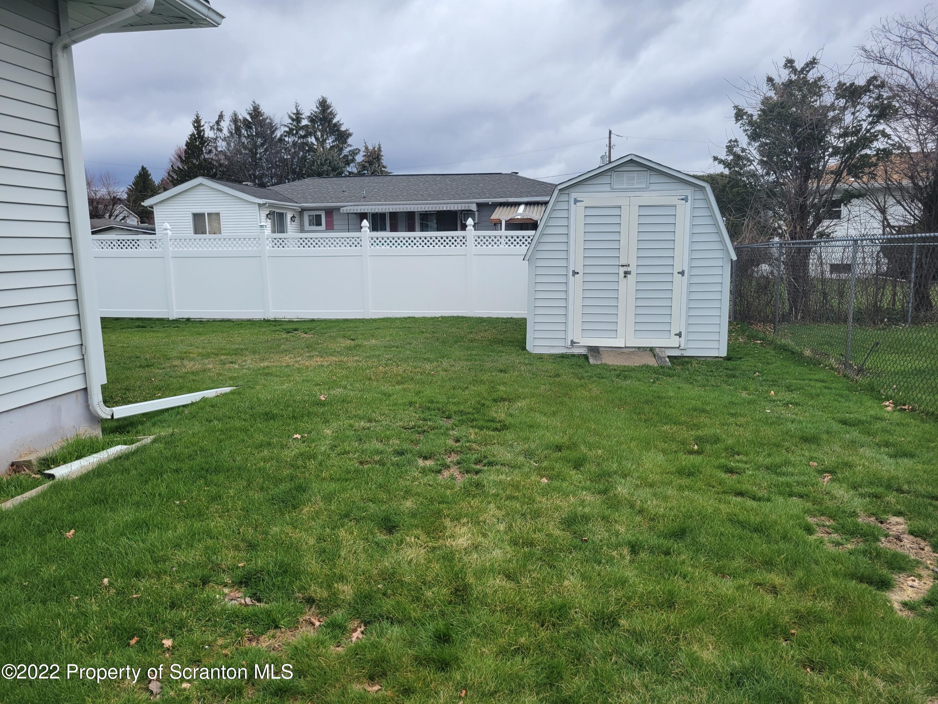 106 Billy Lane Taylor, PA 18517 - Photo 13 of 15 a view of a house with a backyard and a garden