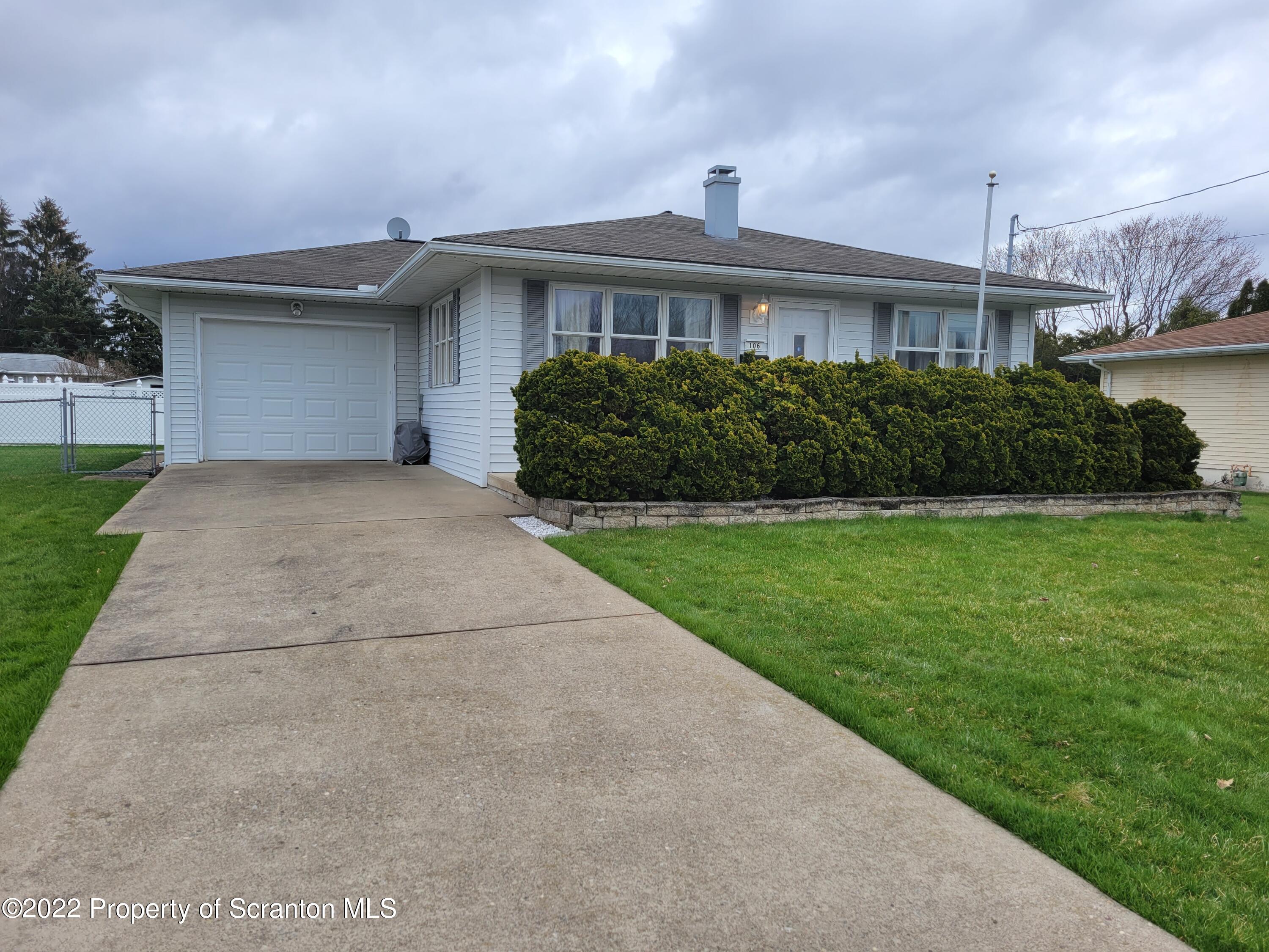 106 Billy Lane Taylor, PA 18517 - Photo 2 of 15 a view of a house with a yard and a garage