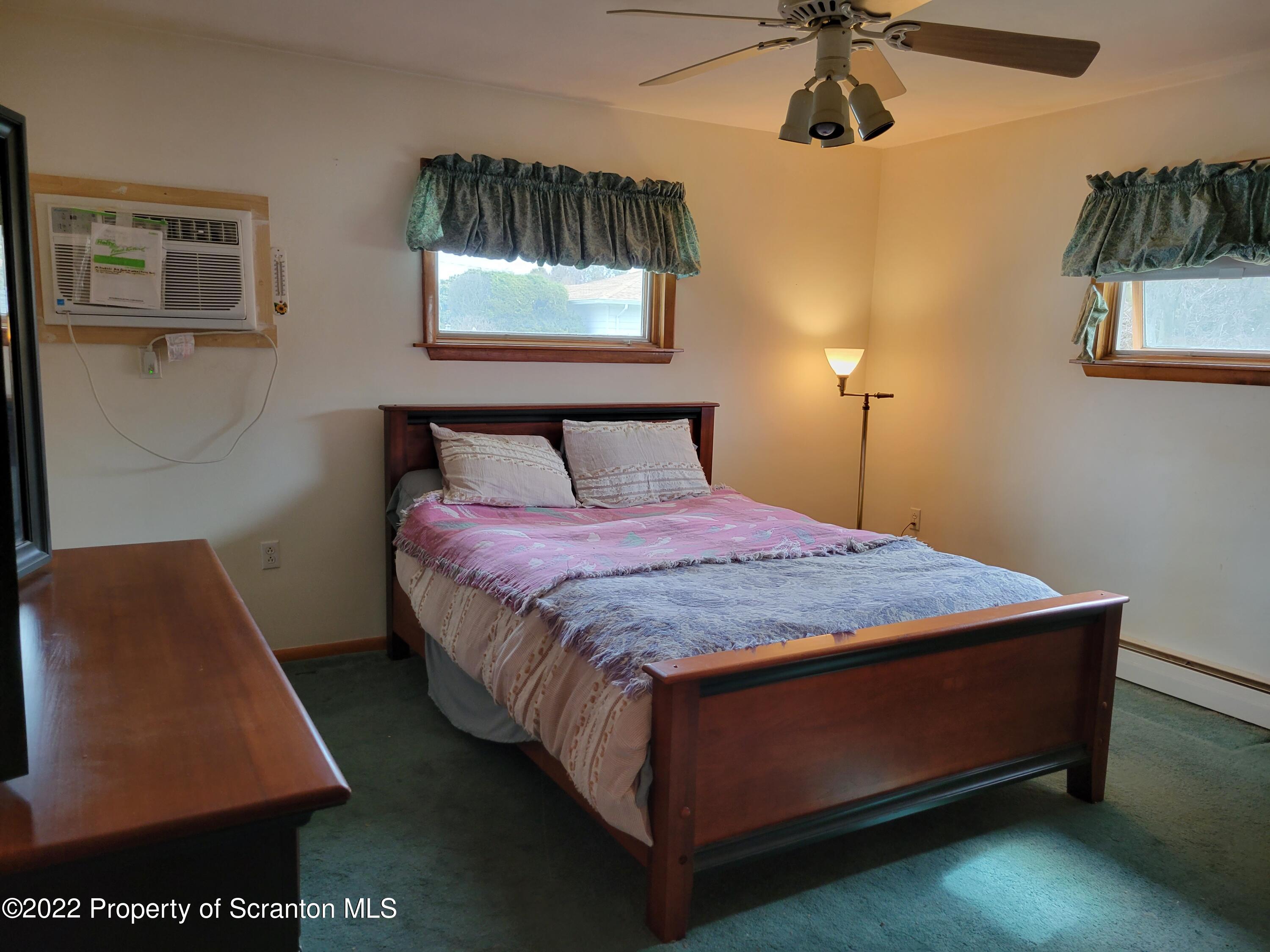 106 Billy Lane Taylor, PA 18517 - Photo 7 of 15 a bed sitting in a bedroom next to a window