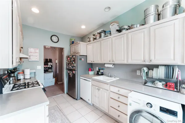 a kitchen with refrigerator and cabinets