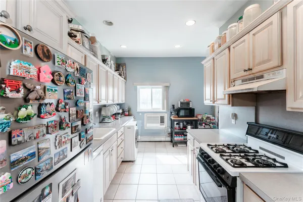a kitchen with lots of clutter and stainless steel appliances
