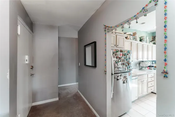 a kitchen with white cabinets and white appliances
