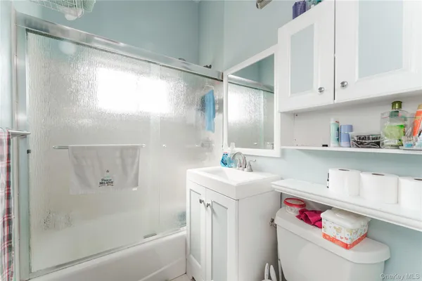 a bathroom with a sink toilet vanity and tub