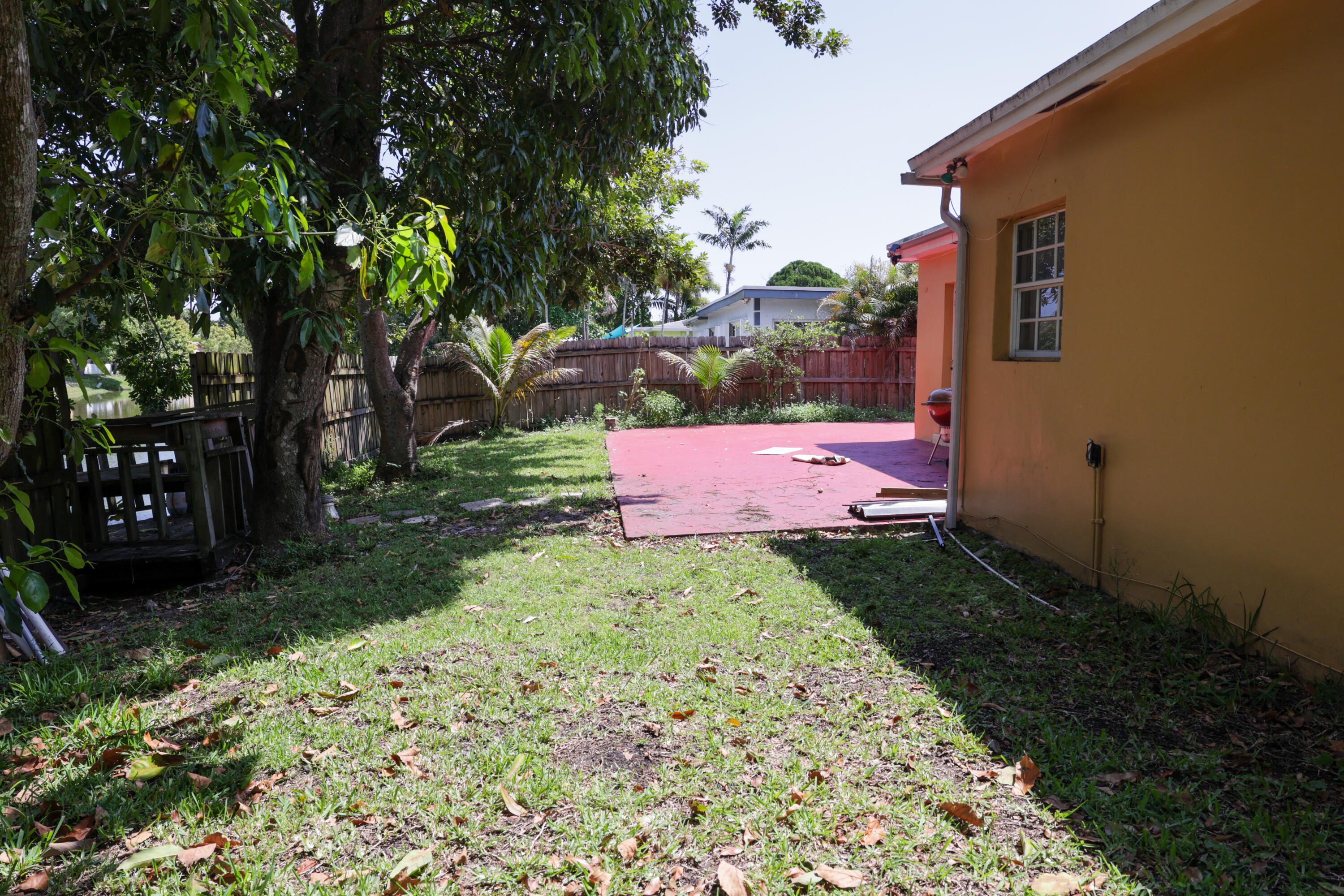5380 Southwest 10th Street Margate, FL 33068 - Photo 2 of 7 a view of a yard with plants and a large tree