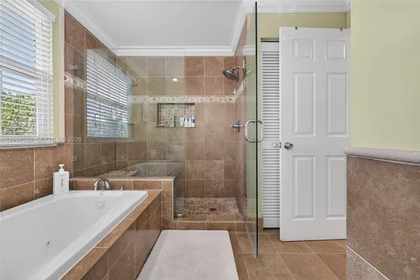 a bathroom with a sink a toilet a mirror and shower