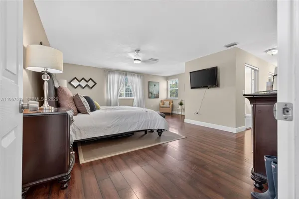 a spacious bedroom with a bed and a large window