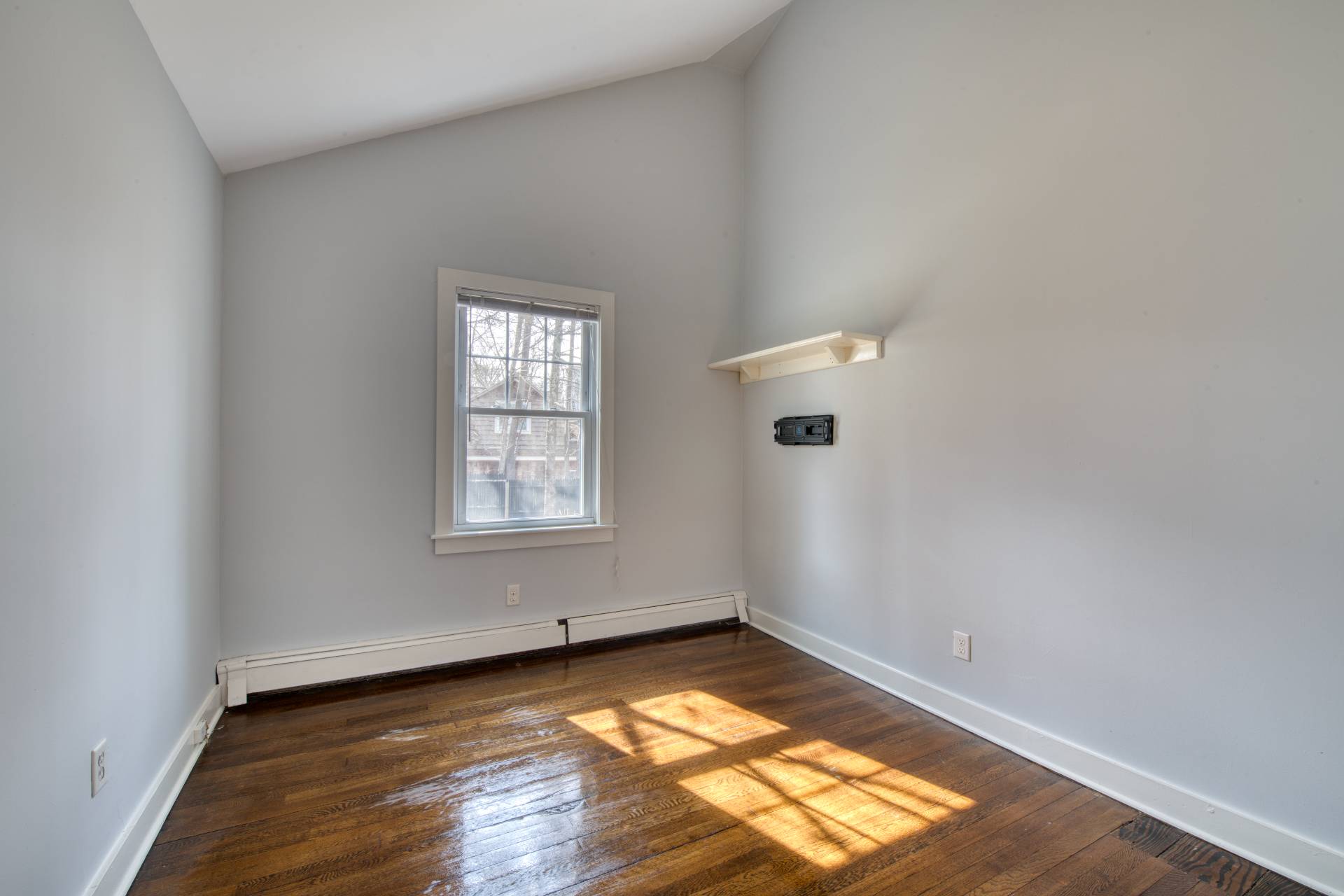 205 Little Fresh Pond Road Southampton, NY 11968 - Photo 11 of 20 an empty room with wooden floor and windows