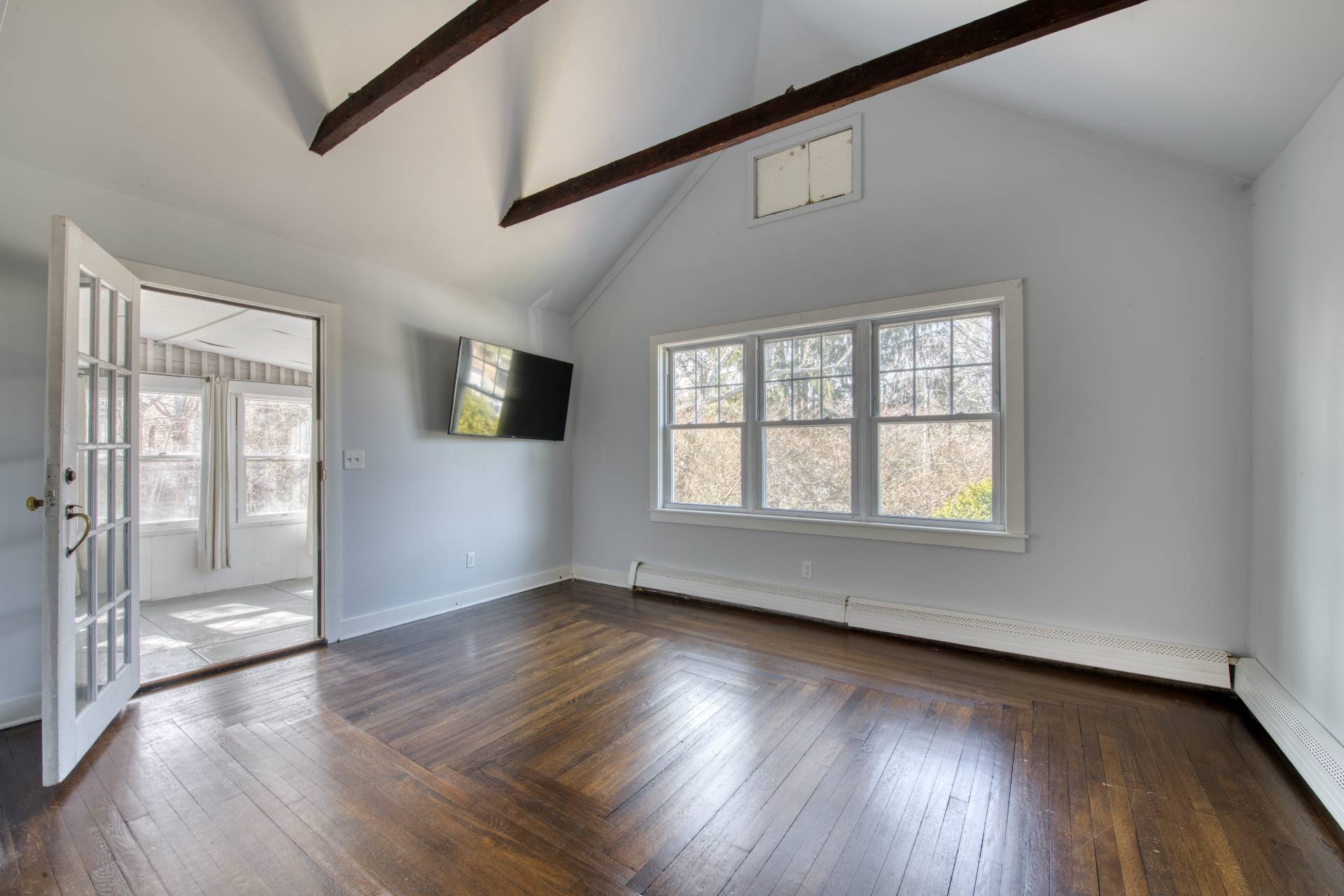 205 Little Fresh Pond Road Southampton, NY 11968 - Photo 3 of 20 a view of an empty room with wooden floor and a window