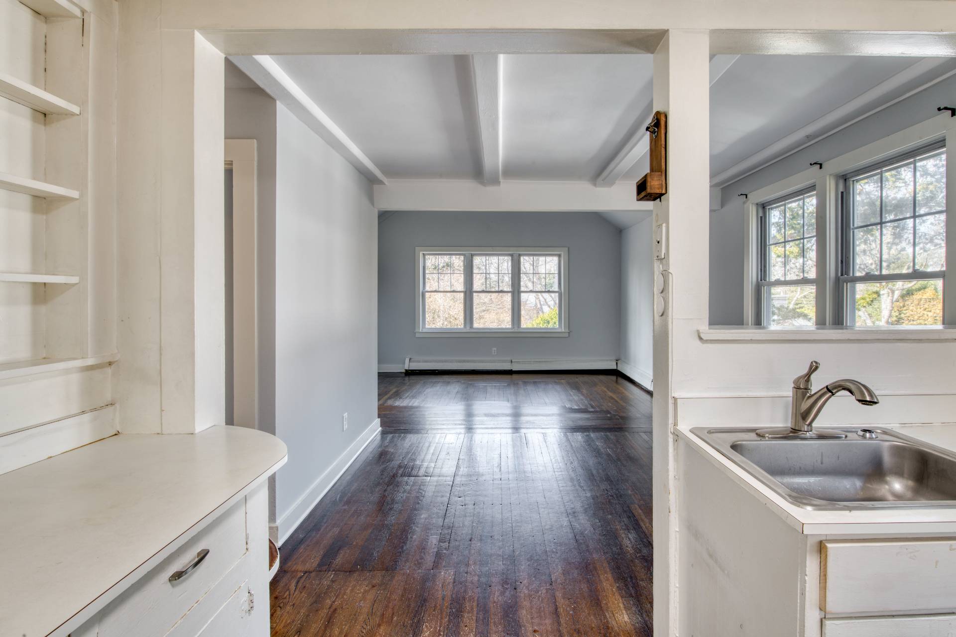 205 Little Fresh Pond Road Southampton, NY 11968 - Photo 5 of 20 a view of a livingroom with wooden floor and a kitchen space