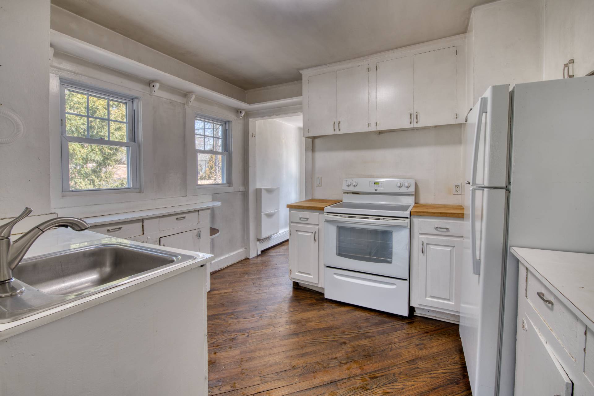205 Little Fresh Pond Road Southampton, NY 11968 - Photo 6 of 20 a kitchen with a refrigerator and a sink