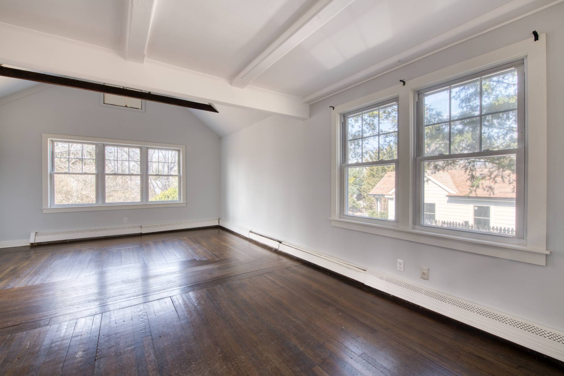 205 Little Fresh Pond Road Southampton, NY 11968 - Photo 9 of 20 an empty room with wooden floor and windows