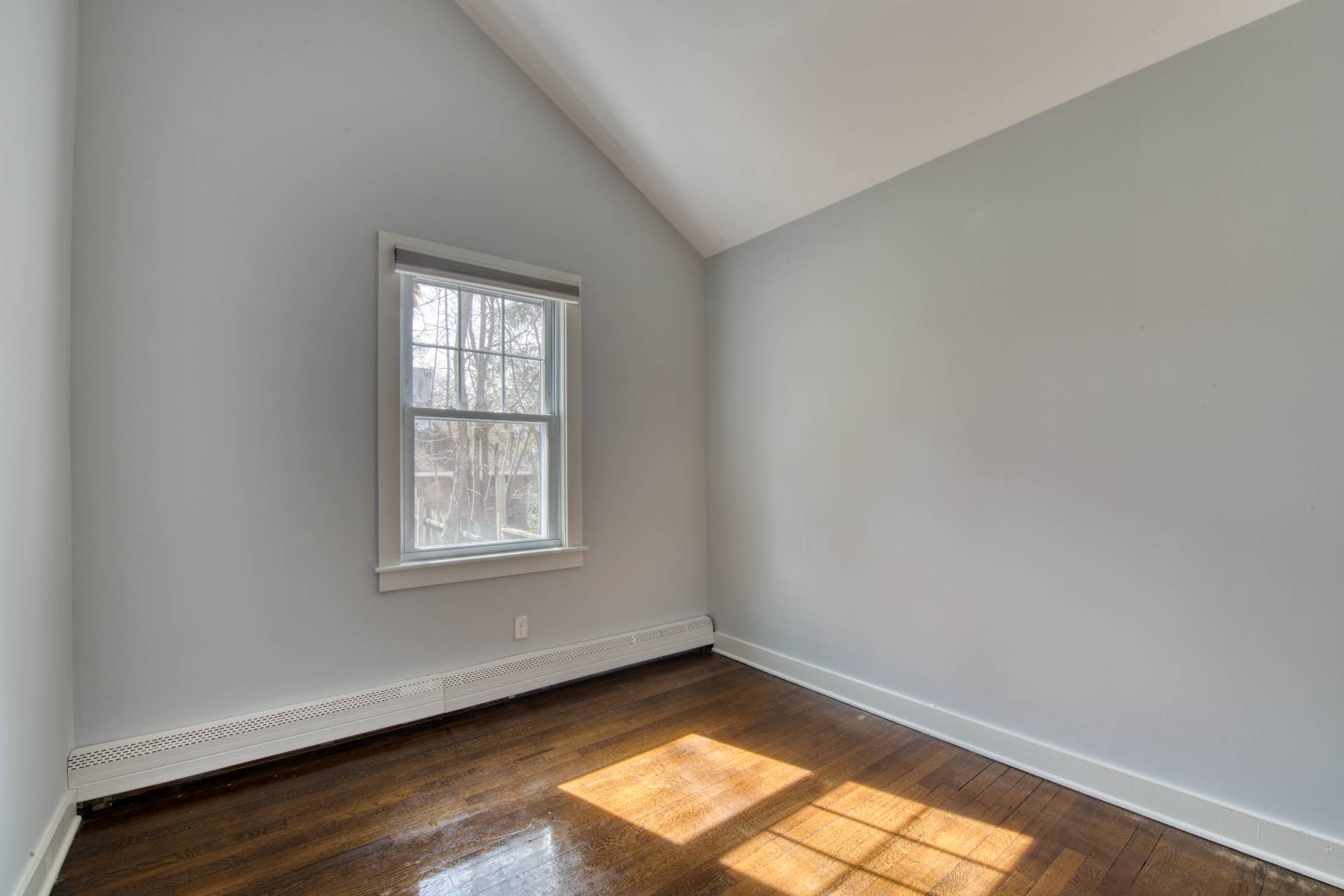 205 Little Fresh Pond Road Southampton, NY 11968 - Photo 10 of 20 an empty room with wooden floor and windows