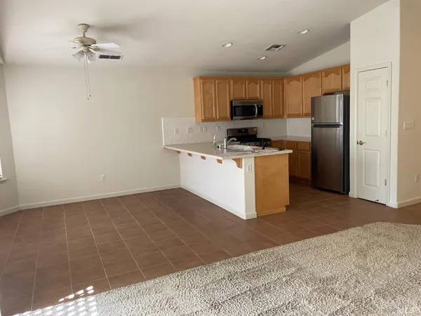 a kitchen with stainless steel appliances a refrigerator a stove a microwave a sink and cabinets