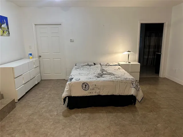 a bedroom with a bed and a table