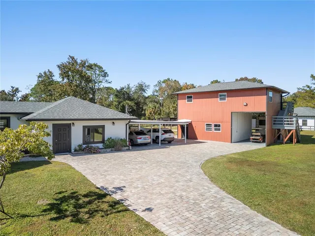 a front view of a house with yard patio and fire pit