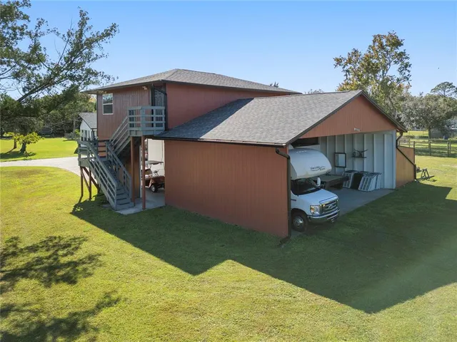 a view of a house with backyard porch and sitting area