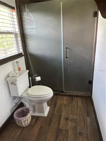 a white toilet sitting next to a window