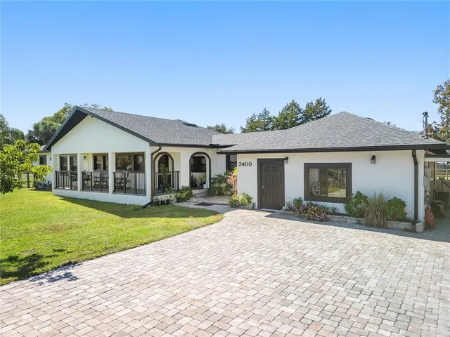 a front view of a house with a yard and porch