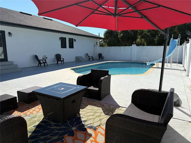 a view of a chairs and table in the patio
