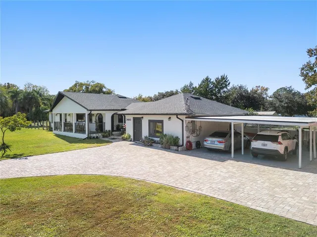 a view of a house with patio and a yard