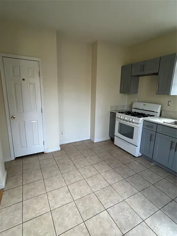a kitchen with a stove top oven and cabinets