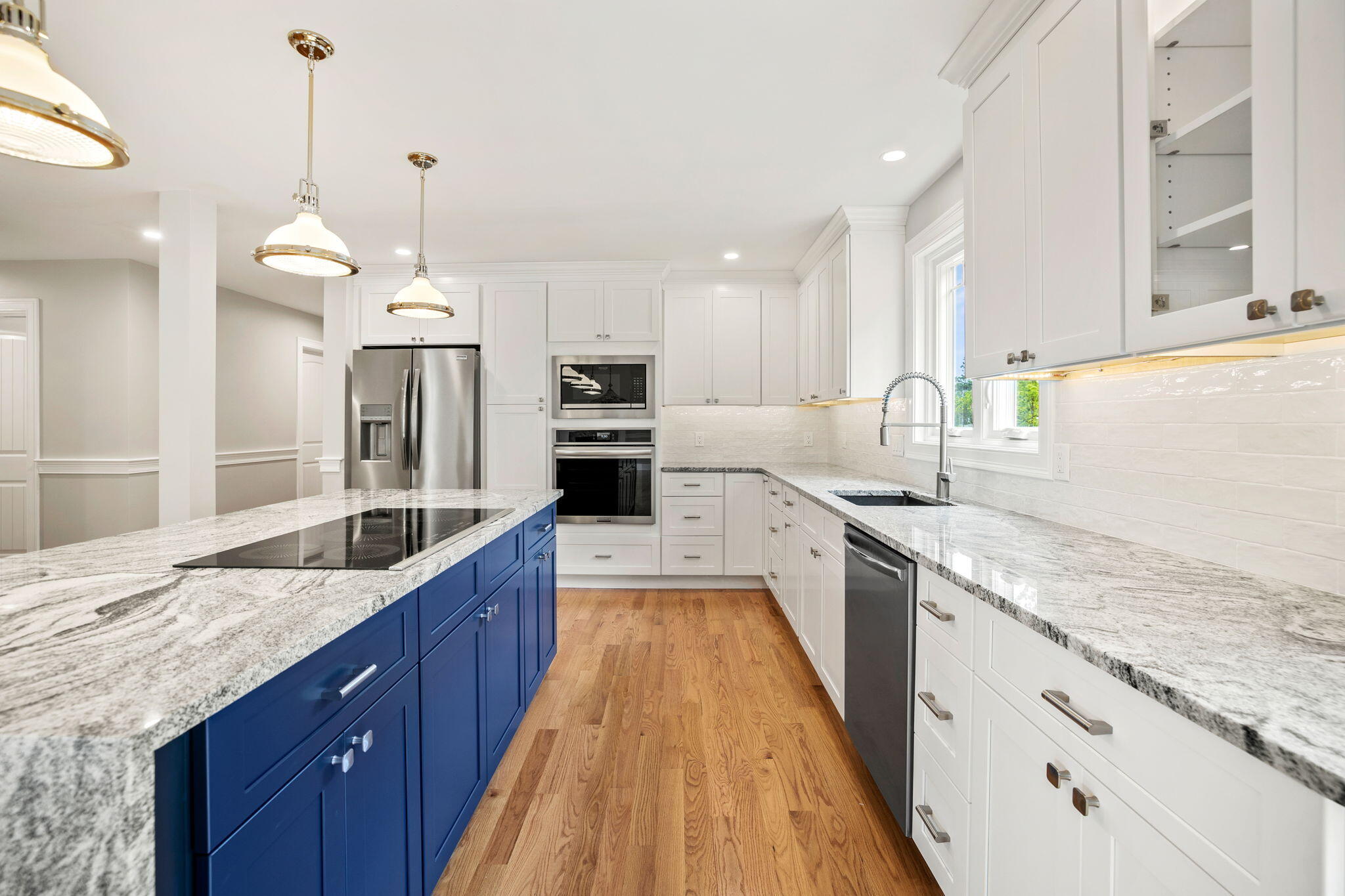 Undisclosed Address Sagamore Beach, MA 02562 - Photo 34 of 43 a large kitchen with granite countertop a large island in the center a sink a counter space and stainless steel appliances