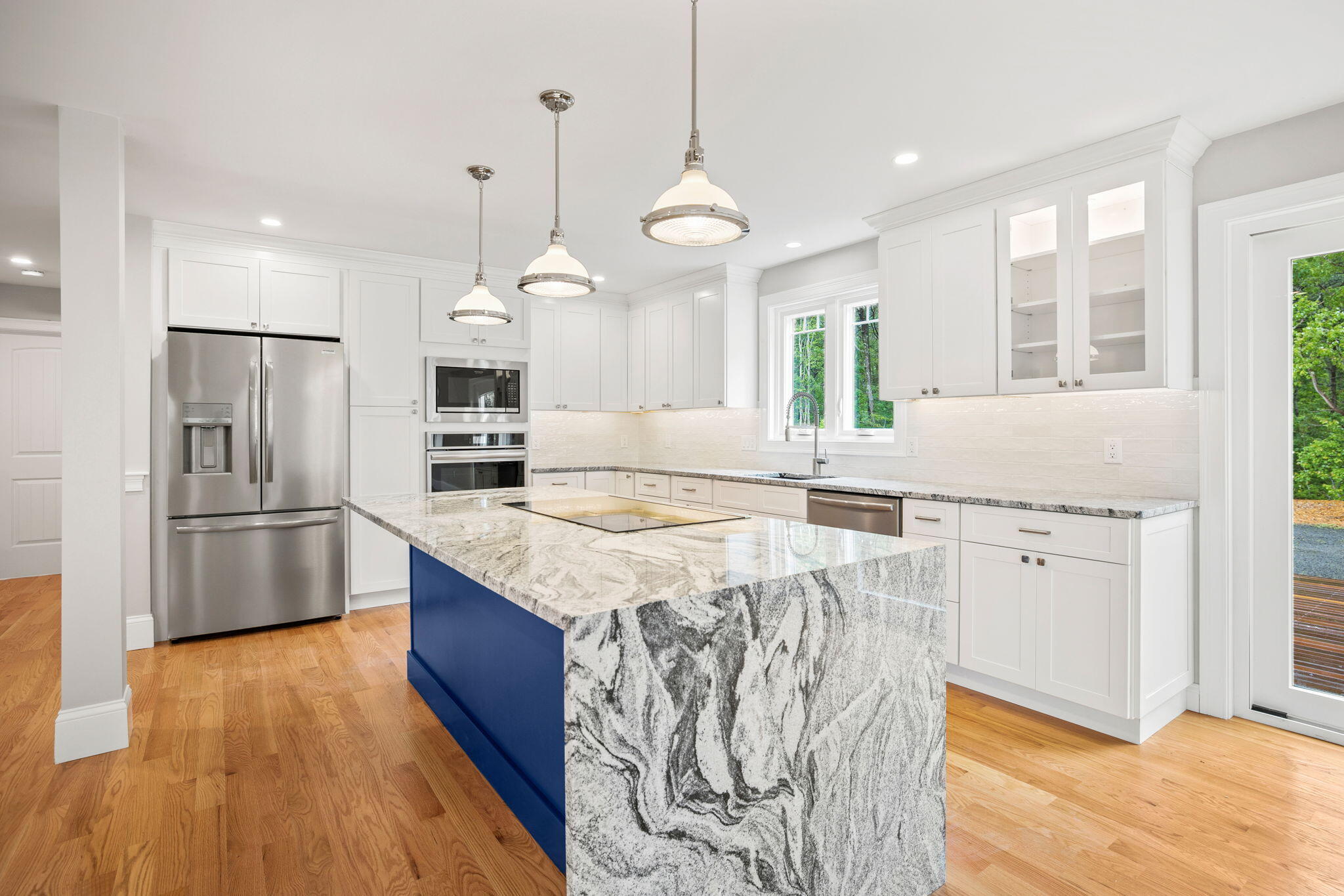 Undisclosed Address Sagamore Beach, MA 02562 - Photo 7 of 43 a large kitchen with granite countertop a sink a counter top space stainless steel appliances and a window