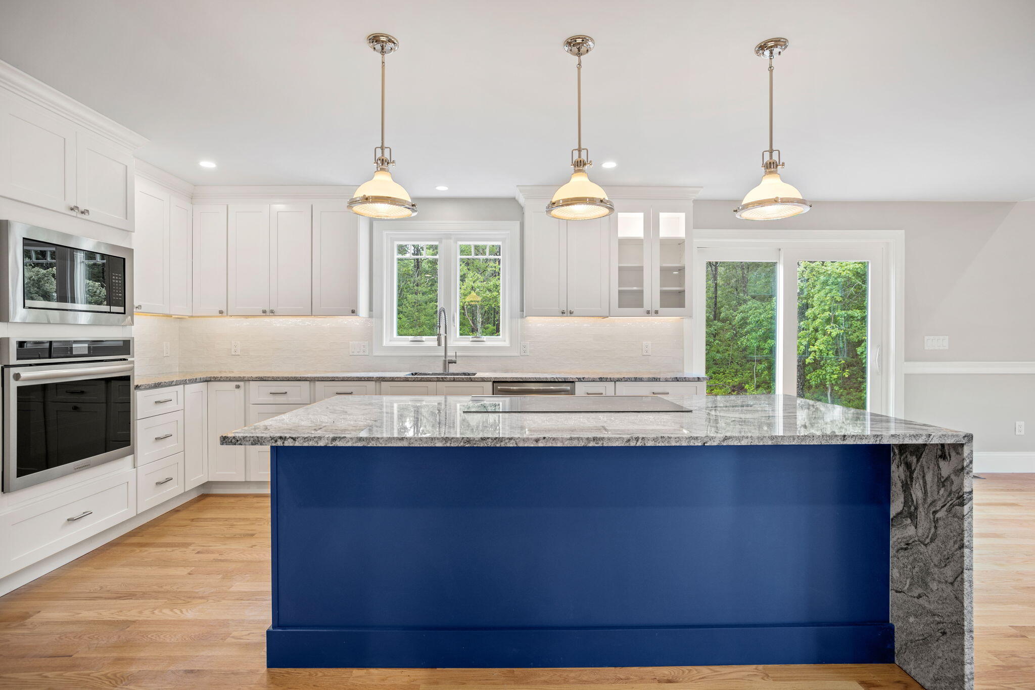 Undisclosed Address Sagamore Beach, MA 02562 - Photo 8 of 43 a kitchen with granite countertop a stove a sink a window and chairs
