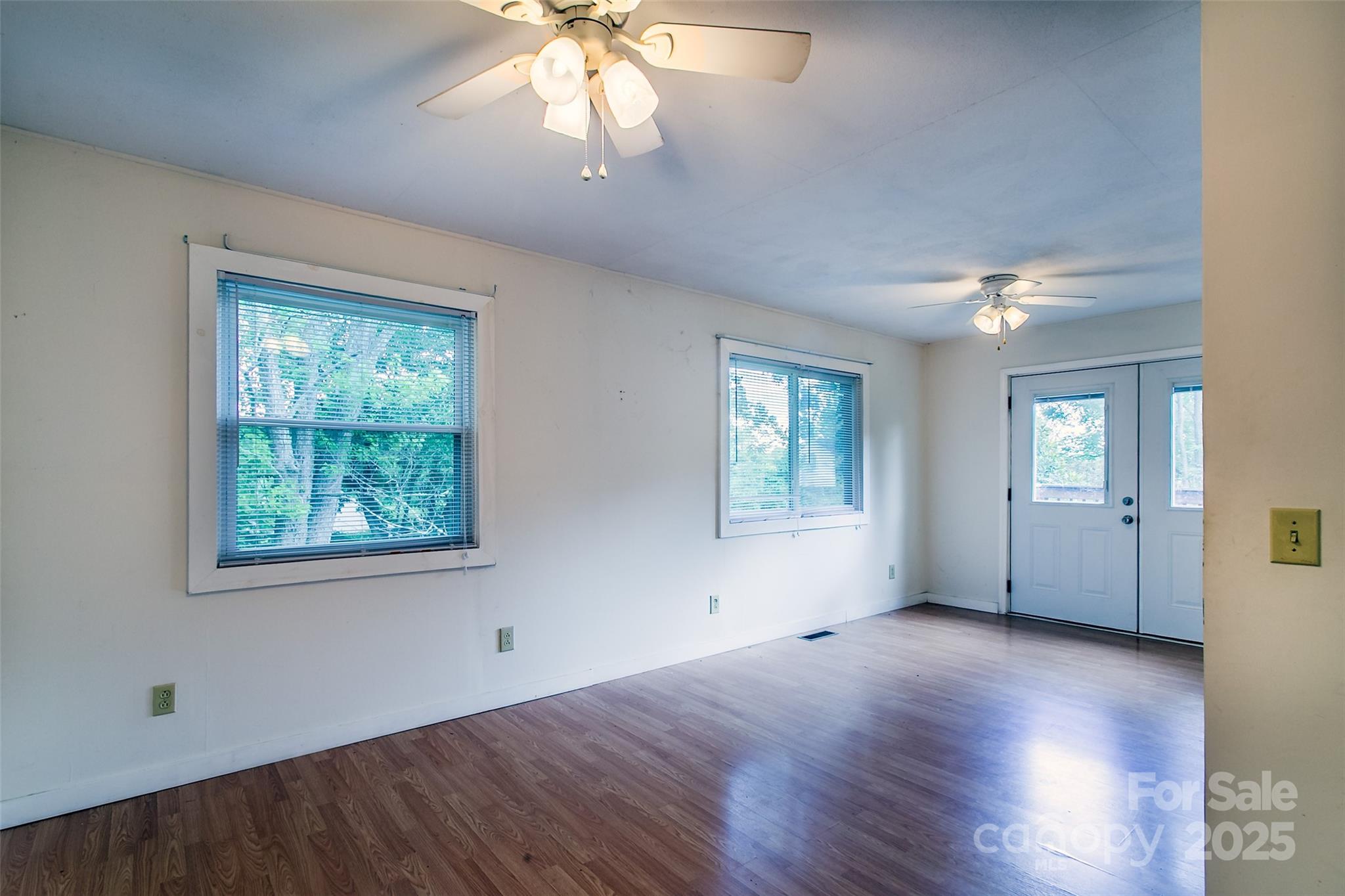 27 Curlee Street Brevard, NC 28712 - Photo 11 of 30 a view of an empty room with wooden floor and a window