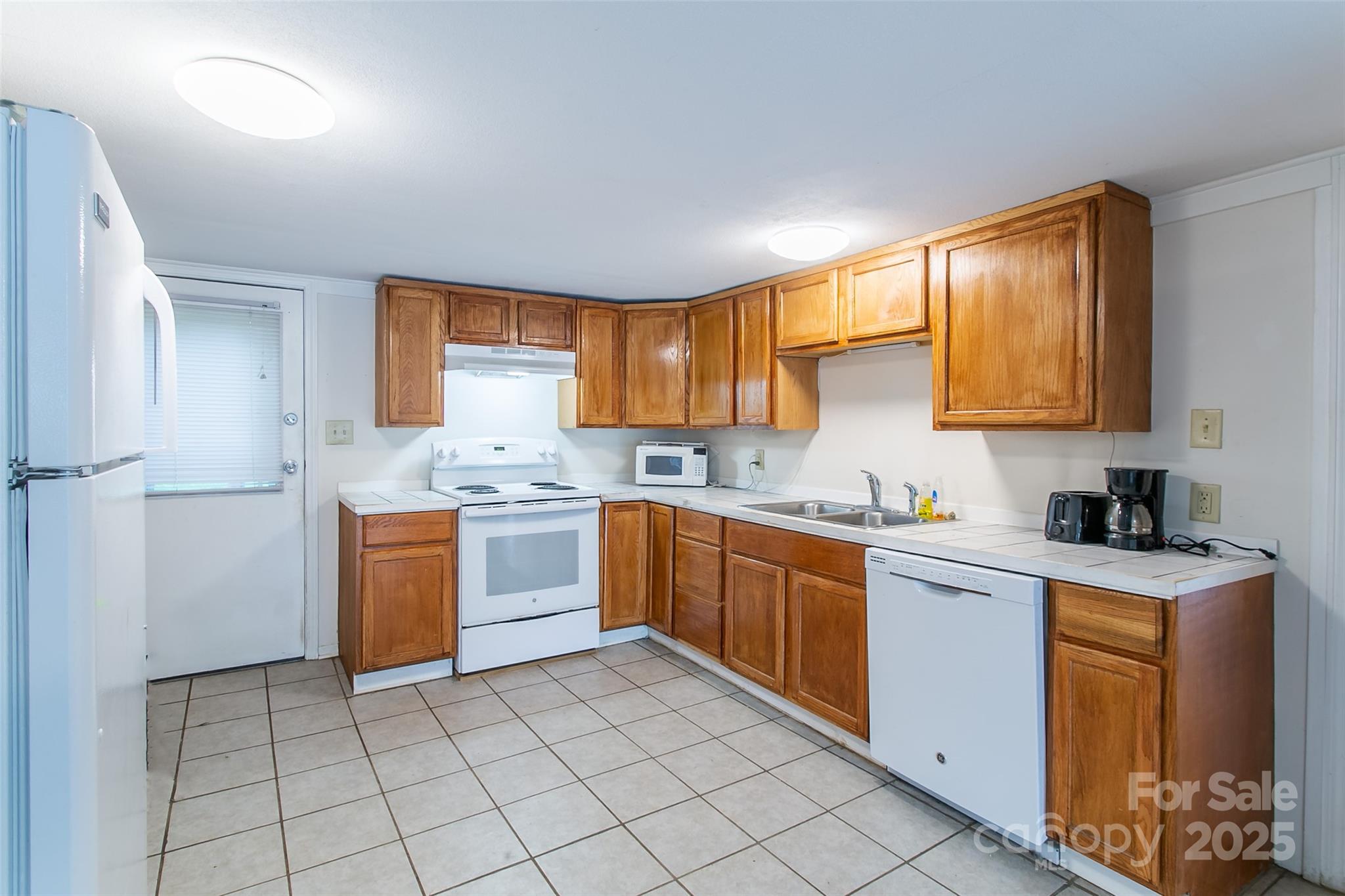 27 Curlee Street Brevard, NC 28712 - Photo 14 of 30 a kitchen with a sink a stove and cabinets