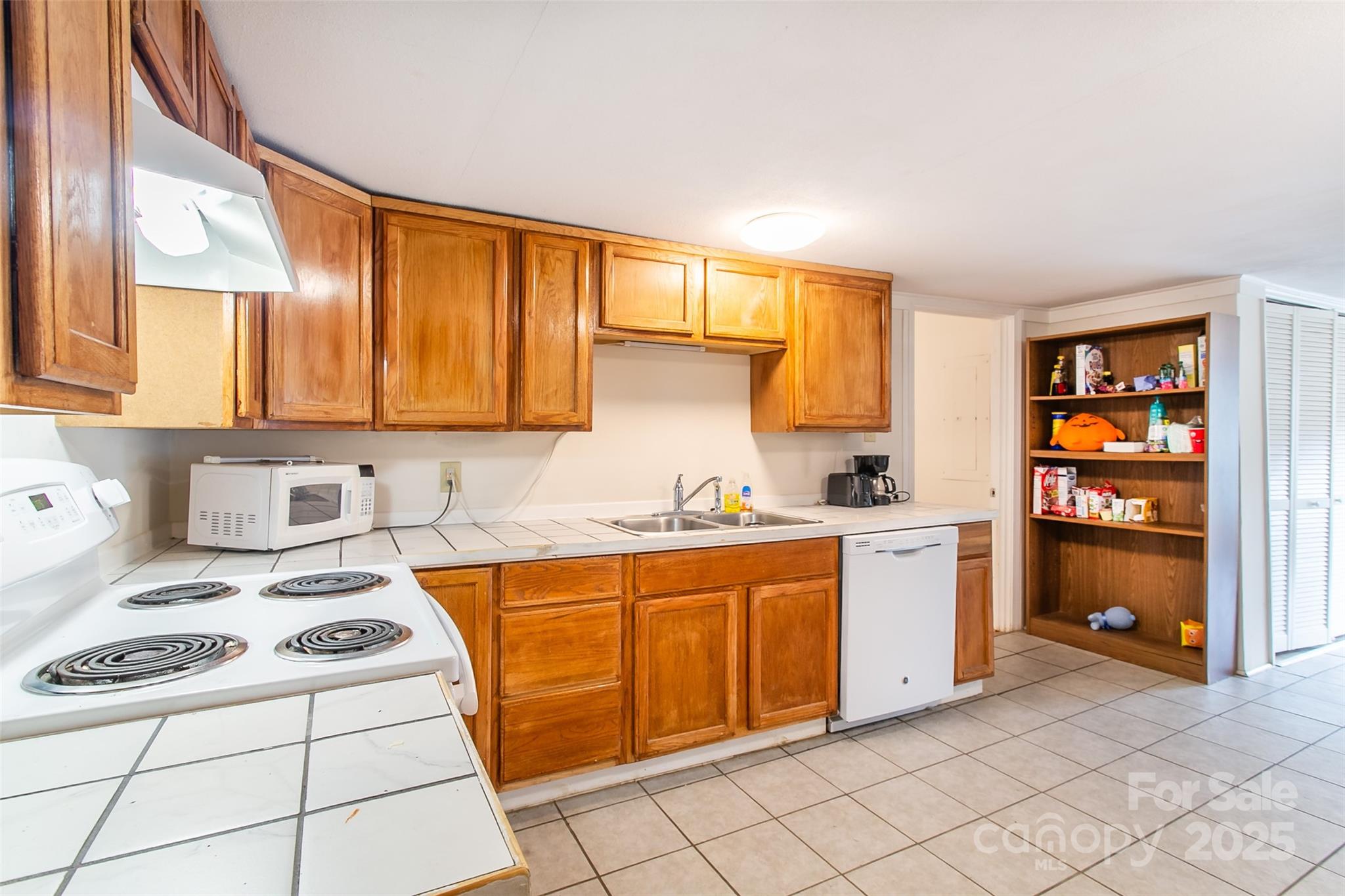 27 Curlee Street Brevard, NC 28712 - Photo 15 of 30 a kitchen with stainless steel appliances a stove a sink and a refrigerator
