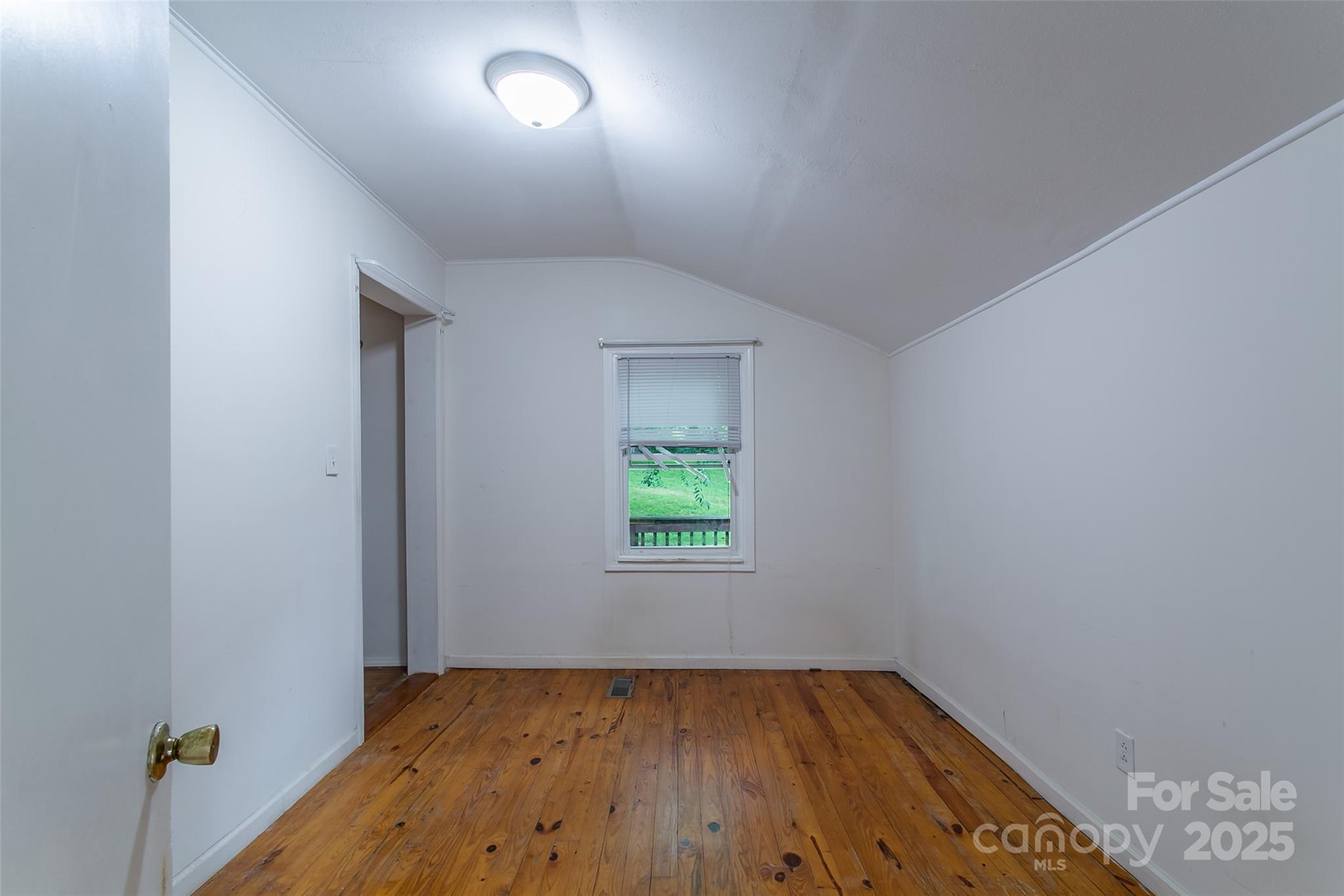 27 Curlee Street Brevard, NC 28712 - Photo 16 of 30 wooden floor in an empty room with a window