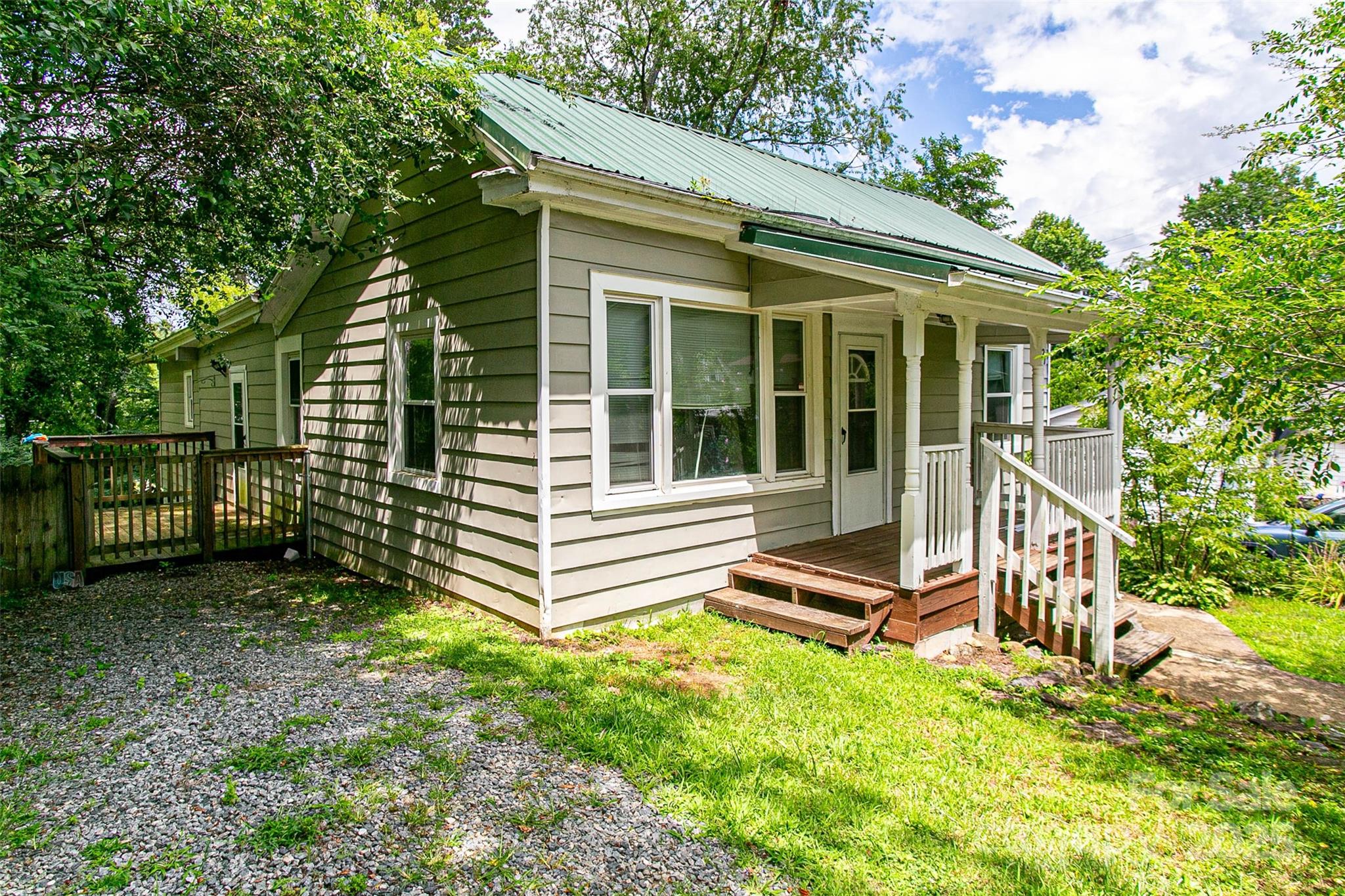 27 Curlee Street Brevard, NC 28712 - Photo 2 of 30 a view of a house with a large window and wooden fence