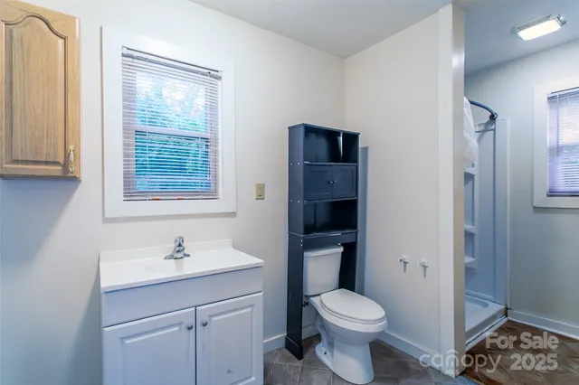 a bathroom with a sink toilet and a mirror