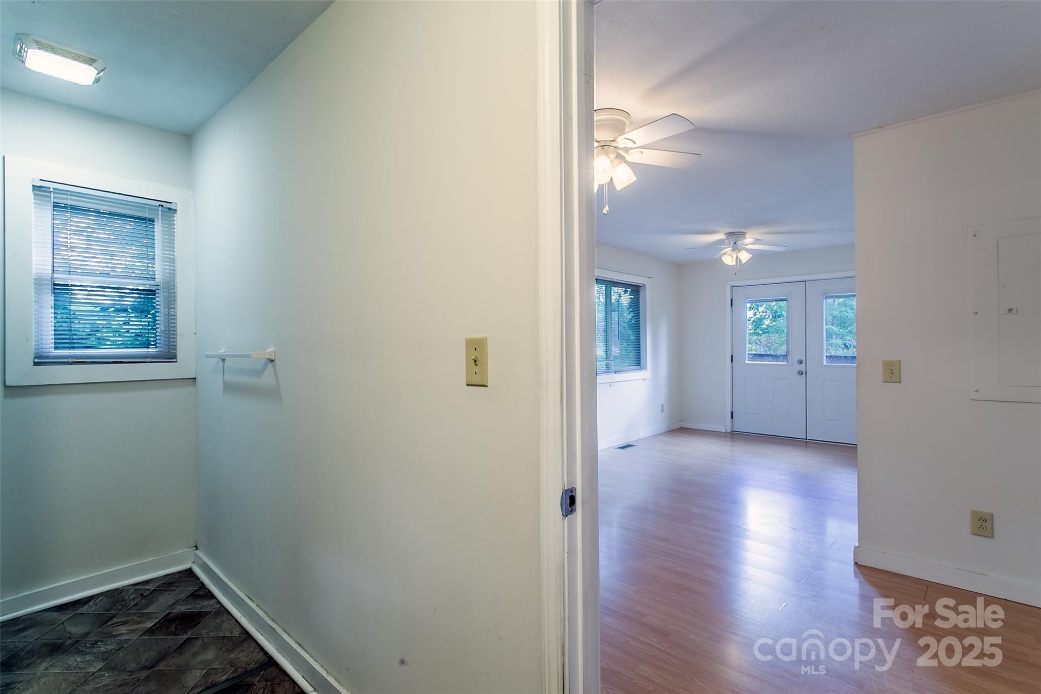 27 Curlee Street Brevard, NC 28712 - Photo 10 of 30 a view of a hallway with wooden floor and a bathroom