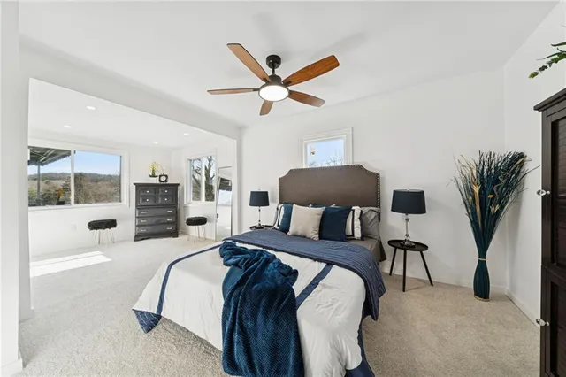 a bedroom with a large bed and a chandelier