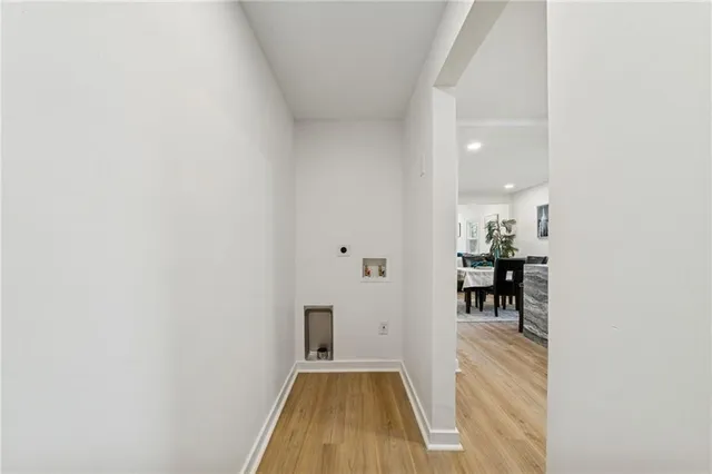 a view of a livingroom with wooden floor and furniture