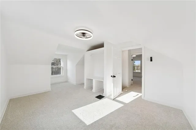 a view of a livingroom with wooden floor and cabinet