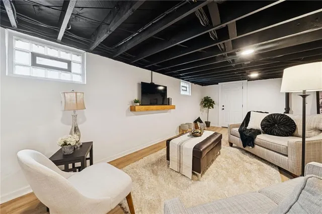 a bedroom with furniture and a wooden floor