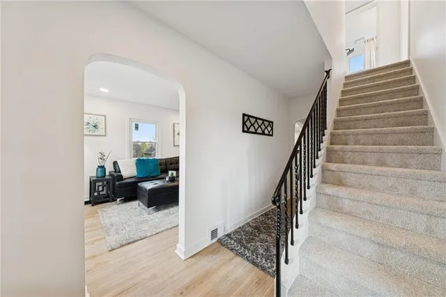 a view of entryway and hall with wooden floor