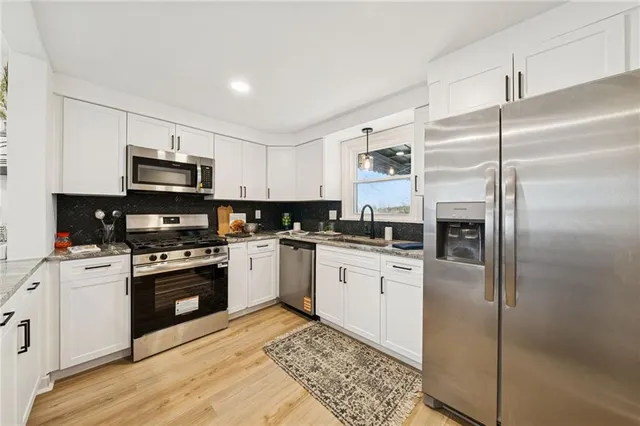 a kitchen with a refrigerator stove and microwave