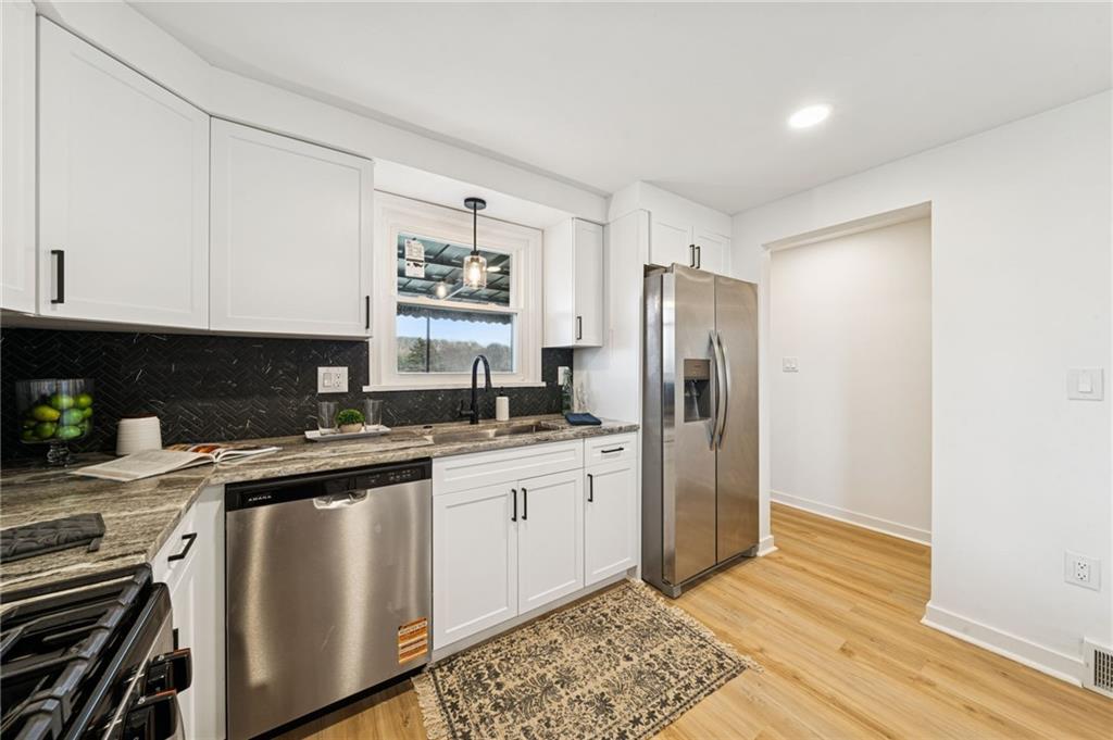 3230 Brodhead Road Aliquippa, PA 15001 - Photo 10 of 38 a kitchen with stainless steel appliances white cabinets and a refrigerator