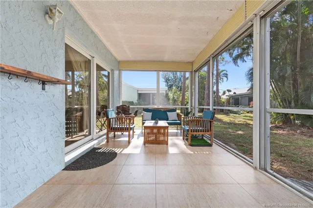 a view of a house with a large window and plants