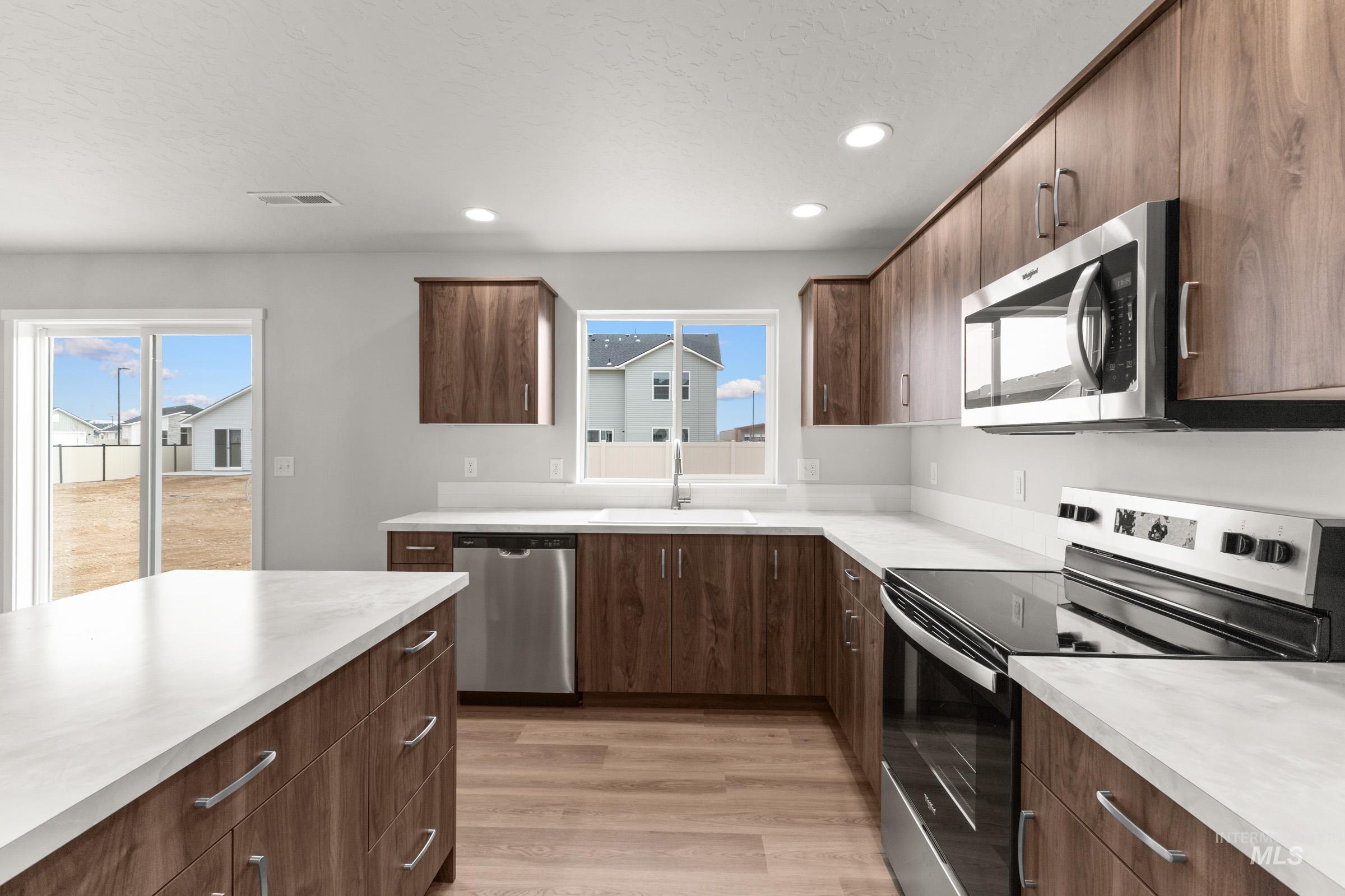 461 Waverly Avenue Middleton, ID 83644 - Photo 5 of 22 Kitchen with stainless steel appliances, light countertops, recessed lighting, light wood finished floors, and plenty of natural light