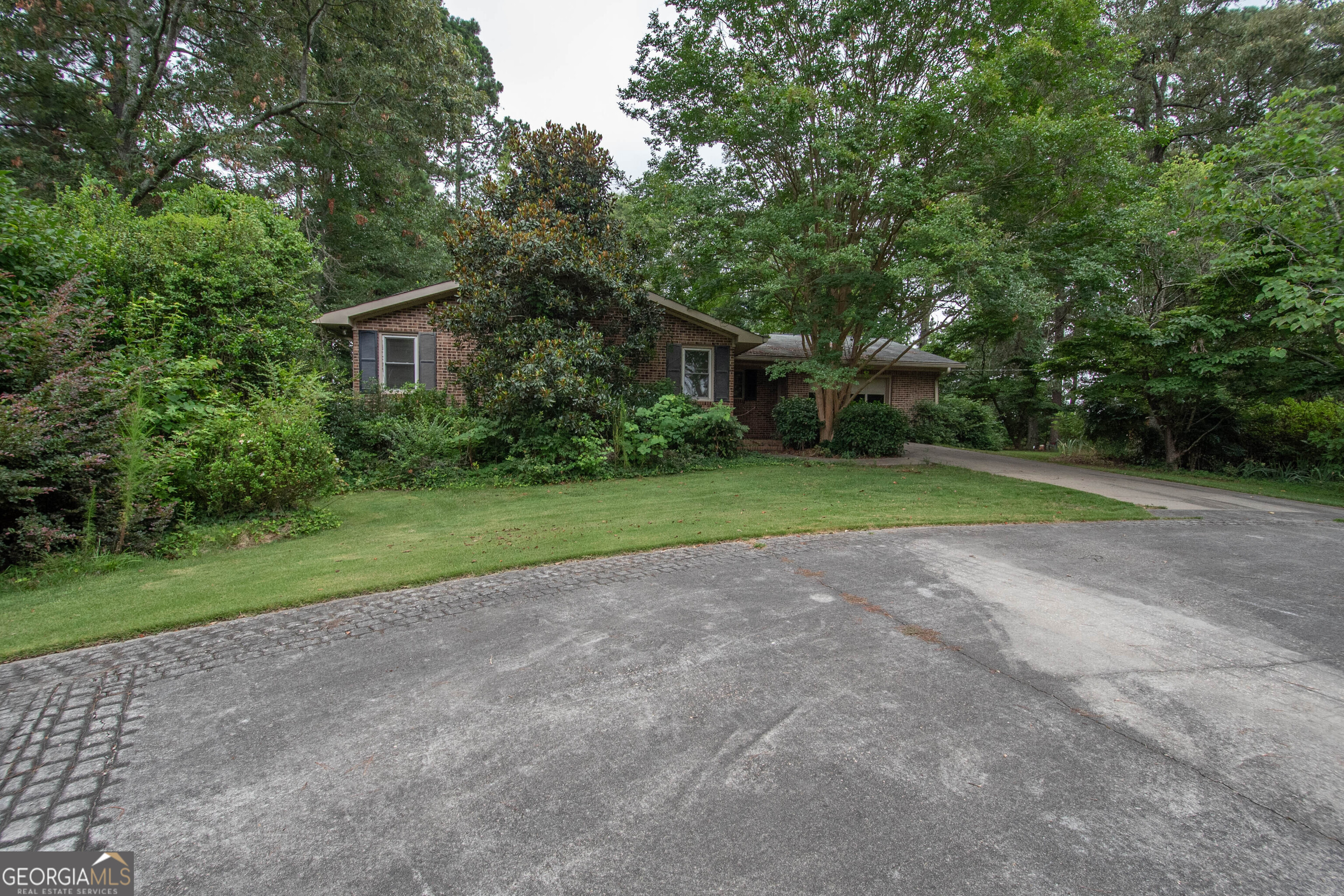1414 Line Creek Road Brooks, GA 30205 - Photo 1 of 1 a view of a house with a yard and large trees