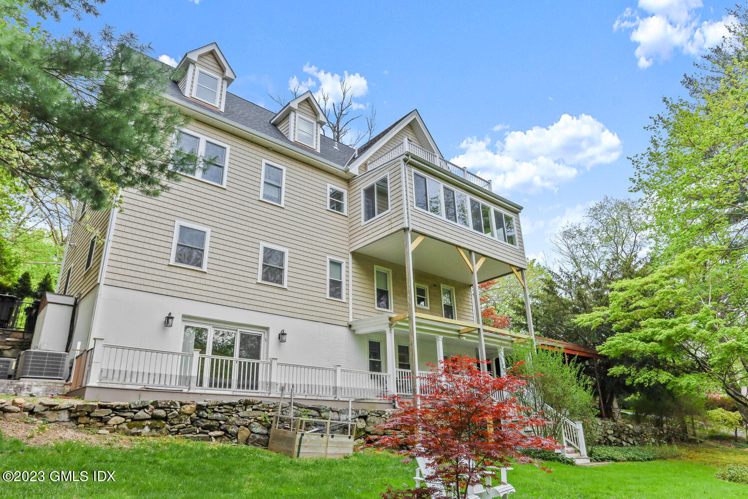 44 Riversville Road, Unit 2 Greenwich, CT 06831 - Photo 19 of 21 a front view of a house with garden