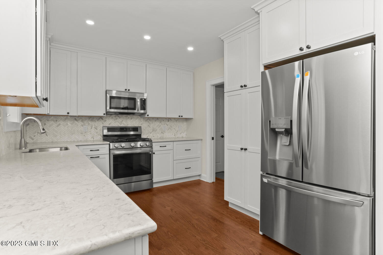 44 Riversville Road, Unit 2 Greenwich, CT 06831 - Photo 5 of 21 a kitchen with stainless steel appliances a refrigerator sink and stove