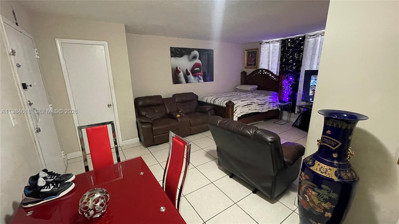 1805 West 56th Street, Unit 113 Hialeah, FL 33012 - Photo 4 of 11 a living room with furniture and a flat screen tv