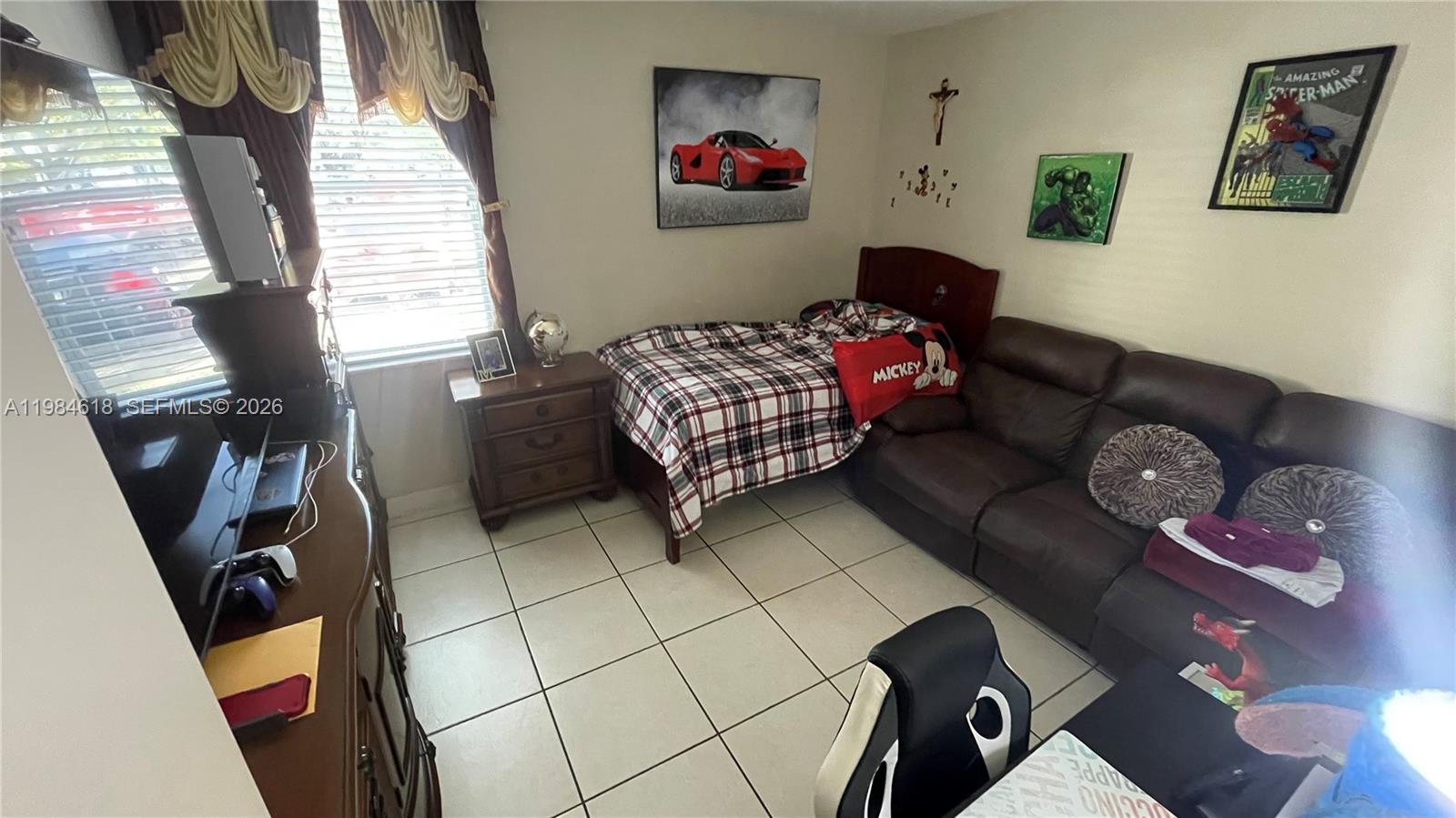 1805 West 56th Street, Unit 113 Hialeah, FL 33012 - Photo 7 of 11 a living room with furniture and a couch